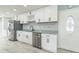 Stylish kitchen with stainless steel appliances, granite countertops, and white cabinets at 1905 Diamond Dr, Orlando, FL 32807