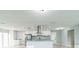 Bright, open kitchen featuring stainless steel appliances, white cabinets, and a stylish range hood at 1905 Diamond Dr, Orlando, FL 32807