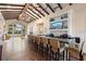 An inviting bar area featuring counter seating and a beverage station with a flat screen TV and decorative shelving at 2017 Flora Pass Pl, Kissimmee, FL 34747
