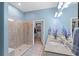 Bright bathroom with granite counters, glass shower, dual sinks, and an adjacent walk-in closet at 2017 Flora Pass Pl, Kissimmee, FL 34747