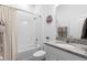 Well-lit bathroom with shower-tub combo, granite-topped vanity, and neutral color scheme at 2017 Flora Pass Pl, Kissimmee, FL 34747