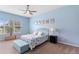 Charming bedroom with blue walls, ceiling fan, large window, and coordinated decor for a relaxing atmosphere at 2017 Flora Pass Pl, Kissimmee, FL 34747