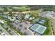Aerial of community amenities featuring a pool, tennis courts, bocce ball, and golf course views at 2017 Flora Pass Pl, Kissimmee, FL 34747