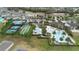 Aerial view of a community center featuring pools, tennis courts, and bocce ball courts at 2017 Flora Pass Pl, Kissimmee, FL 34747