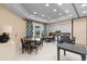 A well-lit room featuring multiple tables, kitchen amenities, and elegant decor, ideal for social gatherings at 2017 Flora Pass Pl, Kissimmee, FL 34747