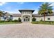 Attractive community clubhouse with lush landscaping, featuring a porte-cochere entrance and well-manicured grounds at 2017 Flora Pass Pl, Kissimmee, FL 34747