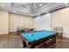 An indoor game room that contains both a billiard table and a ping pong table for leisure activities at 2017 Flora Pass Pl, Kissimmee, FL 34747