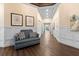 Elegant hallway featuring wainscoting, hardwood floors, and neutral decor with views to the exterior at 2017 Flora Pass Pl, Kissimmee, FL 34747