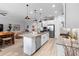 Modern kitchen with a large island, stainless steel appliances, and adjacent living area at 2017 Flora Pass Pl, Kissimmee, FL 34747