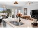 Kitchen with granite countertops and sink, connecting the living room and enclosed patio in an open layout at 2017 Flora Pass Pl, Kissimmee, FL 34747