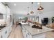 Modern kitchen with white cabinetry, granite countertops, stainless steel appliances, and an island with pendant lighting at 2017 Flora Pass Pl, Kissimmee, FL 34747