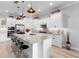 Modern kitchen features stainless appliances, white cabinets, granite countertops and a large kitchen island at 2017 Flora Pass Pl, Kissimmee, FL 34747