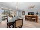 Open living room featuring dining area, bar seating, sliding glass doors to the patio and light, neutral tones at 2017 Flora Pass Pl, Kissimmee, FL 34747