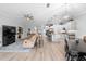 Open concept with kitchen view, dining area and living room that features light, neutral colors and ample seating at 2017 Flora Pass Pl, Kissimmee, FL 34747