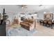 Open concept with kitchen view, dining area and living room that features light, neutral colors and ample seating at 2017 Flora Pass Pl, Kissimmee, FL 34747