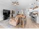 Open concept with kitchen view, dining area and living room that features light, neutral colors and ample seating at 2017 Flora Pass Pl, Kissimmee, FL 34747