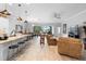 Open-concept living space with kitchen bar, dining area, and cozy seating for modern living at 2017 Flora Pass Pl, Kissimmee, FL 34747