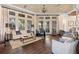 Bright and airy lounge area with comfortable seating, hardwood floors, and large windows with pleasant outdoor views at 2017 Flora Pass Pl, Kissimmee, FL 34747