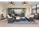 Covered patio with comfortable seating, ceiling fans, and views of the backyard and enclosed lanai at 2017 Flora Pass Pl, Kissimmee, FL 34747