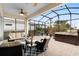 Spacious screened-in patio with comfortable seating, hot tub, and lush landscaping at 2017 Flora Pass Pl, Kissimmee, FL 34747