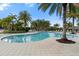 Resort style pool surrounded by tropical landscaping and ample seating at 2017 Flora Pass Pl, Kissimmee, FL 34747