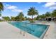 Beautiful community pool surrounded by palm trees and plenty of lounge chairs at 2017 Flora Pass Pl, Kissimmee, FL 34747