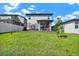 Well-manicured backyard with patio, dining set, grill, and green lawn at 2320 Treasure Hill St, Clermont, FL 34715