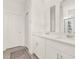 Bright bathroom with double vanity, modern fixtures, and large mirrors at 2320 Treasure Hill St, Clermont, FL 34715