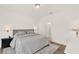 Cozy bedroom features neutral grey walls, a queen bed and en suite bathroom at 2320 Treasure Hill St, Clermont, FL 34715