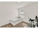 Spare bedroom featuring a twin bed, desk, white chair and a wall of windows at 2320 Treasure Hill St, Clermont, FL 34715