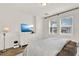 Spacious primary bedroom with a flat screen TV and bright windows at 2320 Treasure Hill St, Clermont, FL 34715