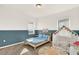 Bright, playful bedroom featuring a twin bed, a whimsical play tent, and stylish decor with blue accent wall at 2320 Treasure Hill St, Clermont, FL 34715