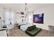 Bright bedroom featuring a modern light fixture, galaxy tapestry, and a cozy green chair at 2320 Treasure Hill St, Clermont, FL 34715