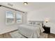 Cozy bedroom featuring neutral grey walls, a queen bed and bright windows at 2320 Treasure Hill St, Clermont, FL 34715