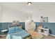 Bright, playful bedroom featuring a twin bed, a whimsical play tent, stylish decor and blue accent wall at 2320 Treasure Hill St, Clermont, FL 34715
