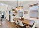 Dining area with a wooden table, stylish chandelier, and open shelving for decor and storage at 2320 Treasure Hill St, Clermont, FL 34715