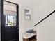Welcoming entryway with a black door, decorative pillows on a bench, and a window at 2320 Treasure Hill St, Clermont, FL 34715