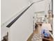 Hallway with hardwood floors leading to the living and dining areas, featuring modern light fixtures at 2320 Treasure Hill St, Clermont, FL 34715