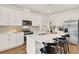 Modern kitchen with white cabinets, stainless steel appliances, quartz countertops, and a center island at 2320 Treasure Hill St, Clermont, FL 34715
