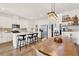 Open-concept kitchen featuring an island with seating, white cabinets, and stainless steel appliances at 2320 Treasure Hill St, Clermont, FL 34715
