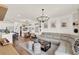 Spacious open-concept living space with a gray sectional sofa, dining area, and modern decor at 2320 Treasure Hill St, Clermont, FL 34715