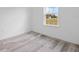 Bright bedroom showcasing a large window and contemporary gray flooring at 2436 Sw 155Th Ln, Ocala, FL 34473