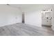 Clean bedroom with closet and bathroom access featuring modern gray flooring and light walls at 2436 Sw 155Th Ln, Ocala, FL 34473