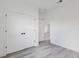 Bright bedroom with modern gray wood-look floors and a closet with double doors at 2436 Sw 155Th Ln, Ocala, FL 34473