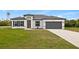 Charming single-story home featuring a modern design, well-manicured lawn, and attached two-car garage at 2436 Sw 155Th Ln, Ocala, FL 34473