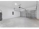 Spacious two-car garage with concrete floor and white cinderblock walls at 2436 Sw 155Th Ln, Ocala, FL 34473