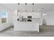 Contemporary kitchen featuring white cabinets, modern stainless steel appliances, and a spacious island at 2436 Sw 155Th Ln, Ocala, FL 34473