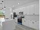 This updated kitchen boasts sleek white cabinets, a modern island, and stainless steel appliances at 2436 Sw 155Th Ln, Ocala, FL 34473