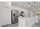 Modern kitchen features white cabinetry, stainless steel appliances, and a large central island at 2436 Sw 155Th Ln, Ocala, FL 34473