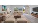 Bright living room featuring stylish furniture, neutral color scheme, and an open doorway at 2436 Sw 155Th Ln, Ocala, FL 34473
